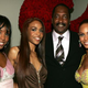Kelly Rowland, Michelle Williams and Beyoncé Knowles pose with their then-manager Mathew Knowles in New York June 23, 2005.
Frank Micelotta/Getty Images